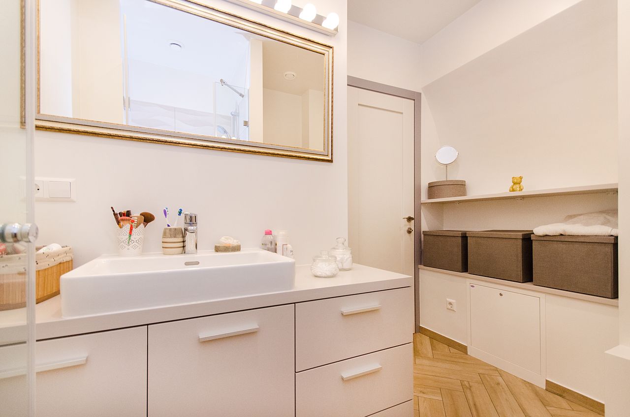 The Art of Drawing Readers In: Your attractive post title goes here Stylish bathroom interior with sleek white vanity and large mirror.